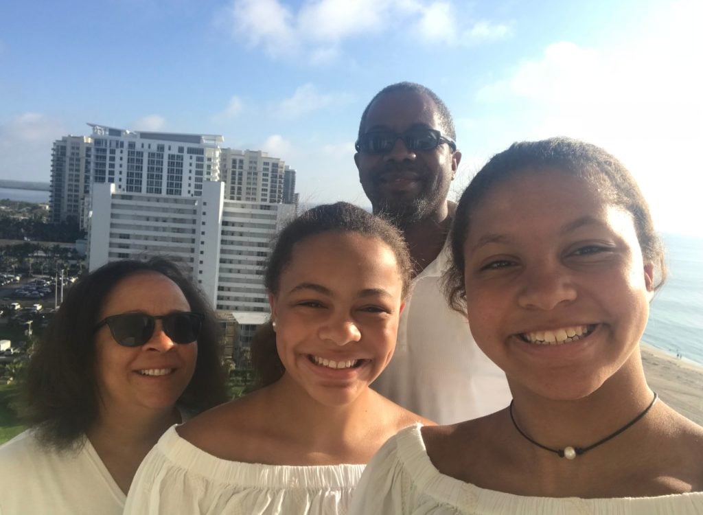 StriveTogether's senior director of marketing and communications, Kelly Anchrum, poses for a selfie with her twin daughters and husband.