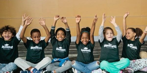 Kids sitting criss cross applesauce at graduate tacoma