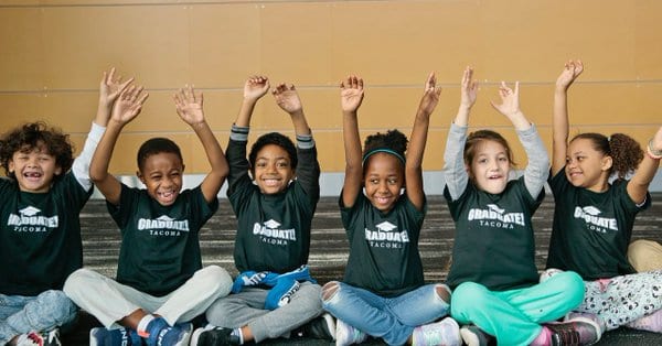 Kids sitting criss cross applesauce at graduate tacoma