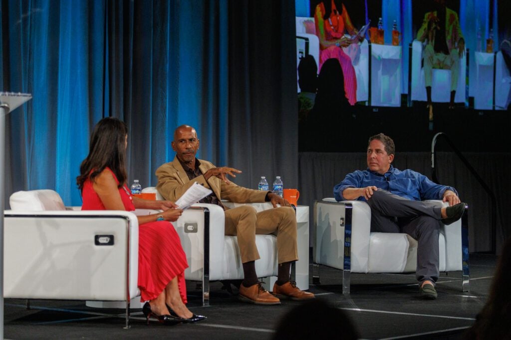 Marcia Quinones, Pedro Noguera and Rick Hess join in conversation, seated on a stage