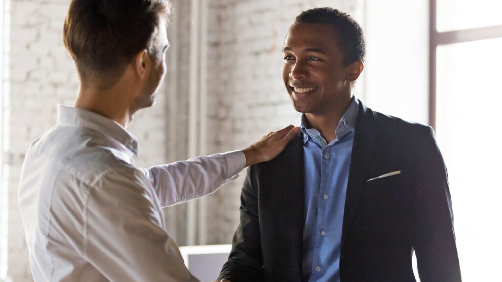 Two business men shaking hands.