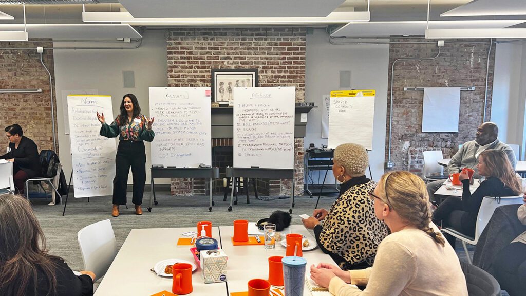 Group of adults learning with female leading the session.